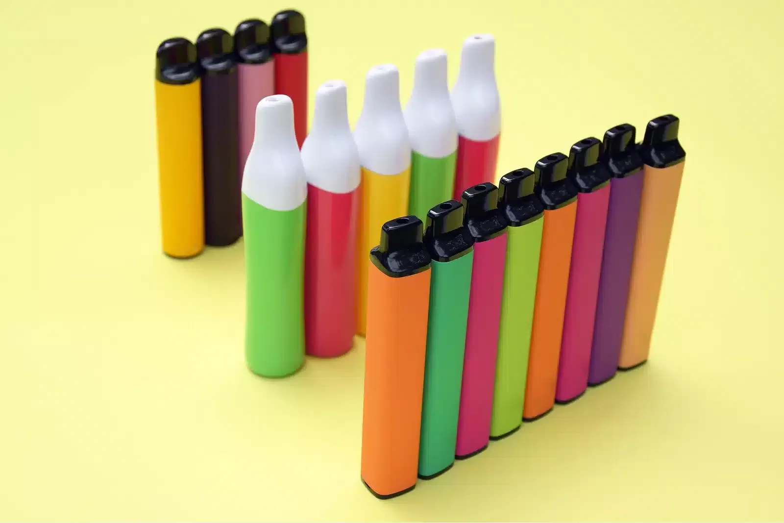 Set Of Multicolor Disposable Electronic Cigarettes On A Bright Y